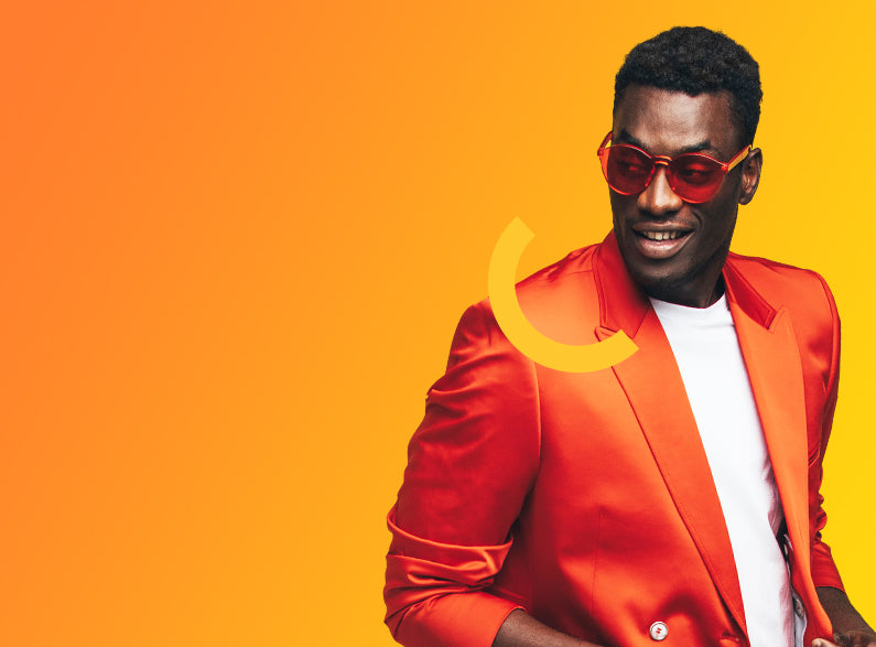 Man wearing a red jacket and sunglasses on an orange and yellow gradient background