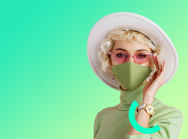 Person wearing a green outfit, white hat, and face mask on a gradient background